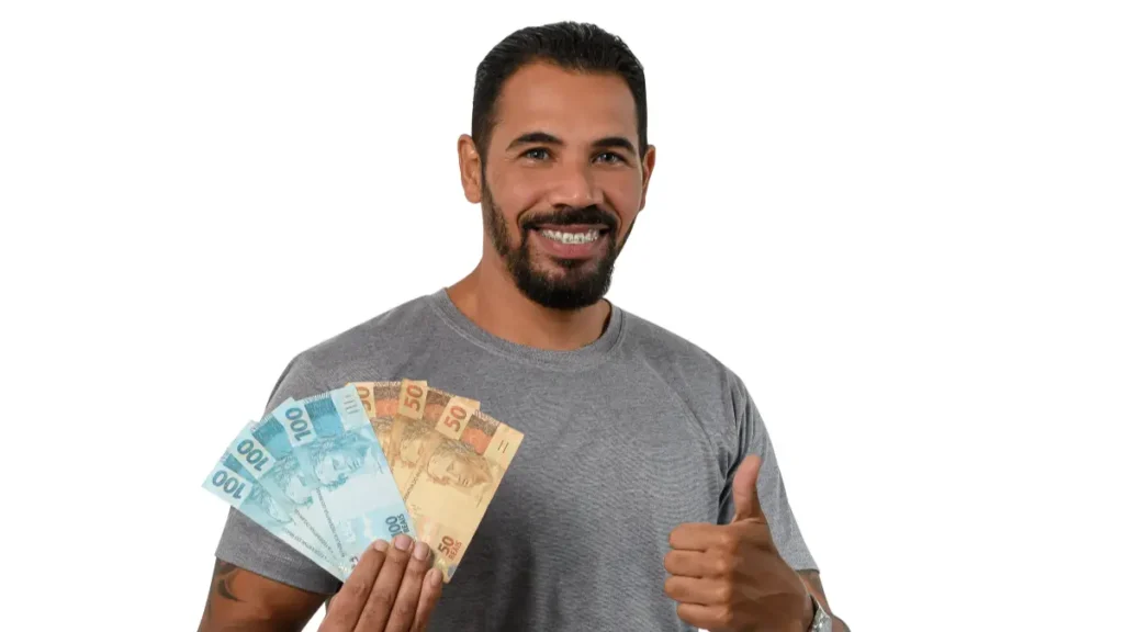 Homem segurando notas de R$100 e R$50.